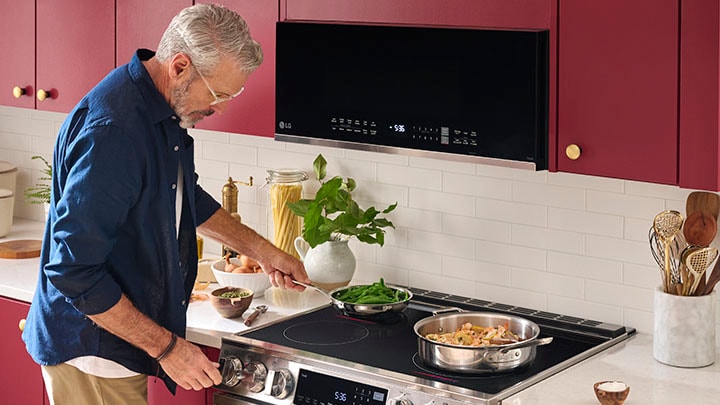 Stainless steel LG low profile over-the-range microwave with a digital display and touch controls.