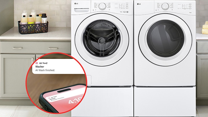 White LG front-load washer and dryer set with a smartphone notification showing an AI Wash finished alert.