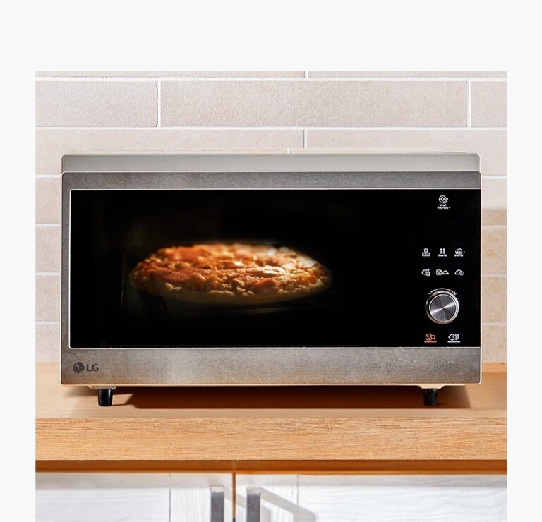 A front view of a microwave oven heating a pie