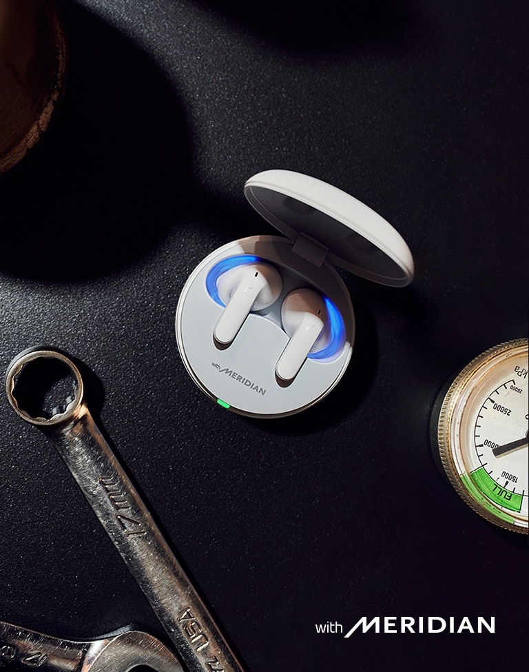 An aerial view of the T60 earbuds inside the cradle, sitting on a tabletop.