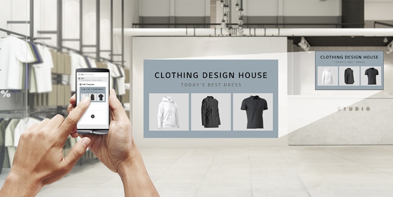 In a clothing store, a user is using the app to produce promotional content to display on the UM5K installed on the store’s wall.