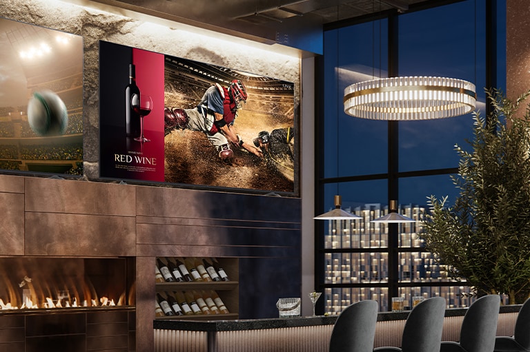 Two displays are installed in the luxurious wine bar. One shows a baseball game scene, and the other displays two images in one screen showing both a red wine commercial advertisement and a baseball game scene.