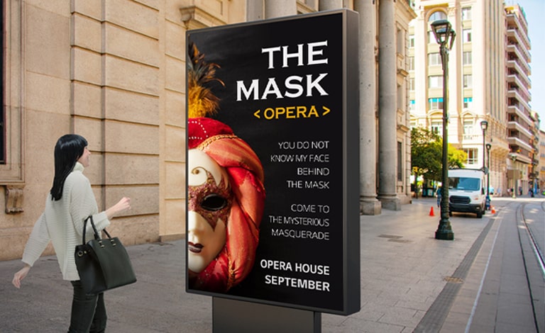 A display as tall as a person is installed at eye level on the street, and a woman who is walking past is watching a clear-image-quality opera advertisement on the display’s screen.