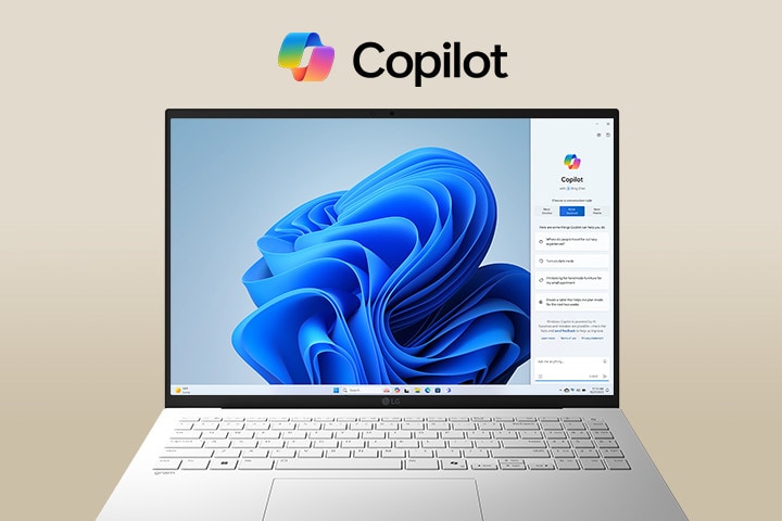 A laptop featuring the Windows Copilot logo above the screen and Windows Copilot interface on the display, showcasing a sleek design with a large screen and the Windows 11 interface in the background.