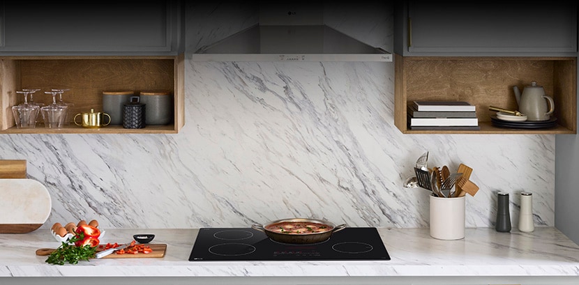 LG induction cooktop seamlessly integrated into a modern kitchen countertop, showcasing a sleek, minimalist design that blends beautifully with surrounding cabinetry.