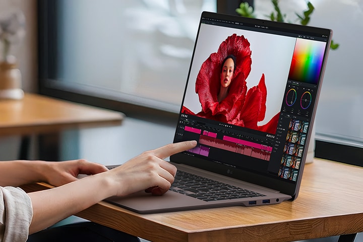 This image shows the LG gram Pro laptop being used for creative editing with touch input, displaying a color grading interface and timeline on the screen.