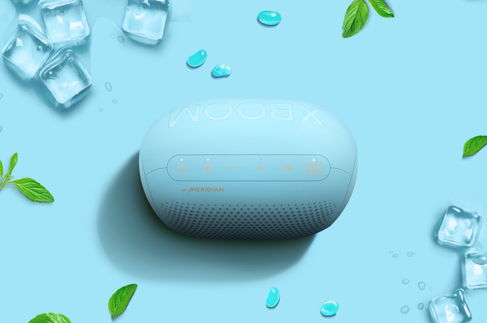 Watermelons, jellybeans, and an LG XBOOM Go PL2B are placed on a green background.