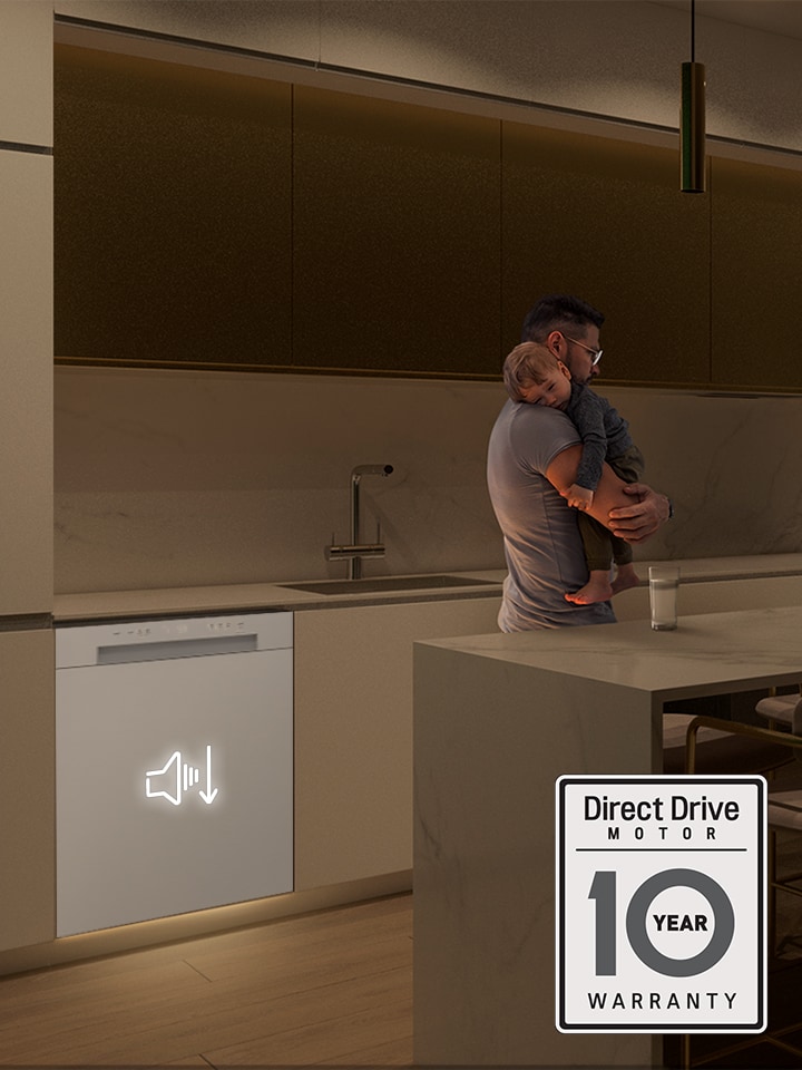 A man holding a sleeping baby in a quiet kitchen next to a white dishwasher with a low-noise icon.