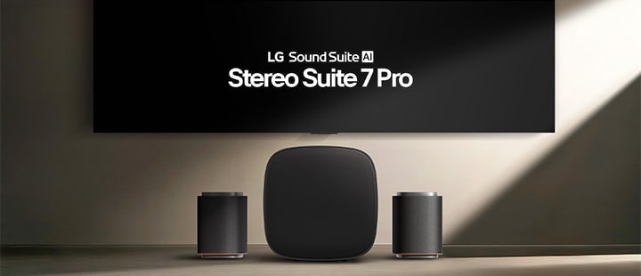A set of Sound Suite M7 speakers and a Sound Suite W7 woofer between them are placed on stands in front of a TV mounted on a gray-toned wall.