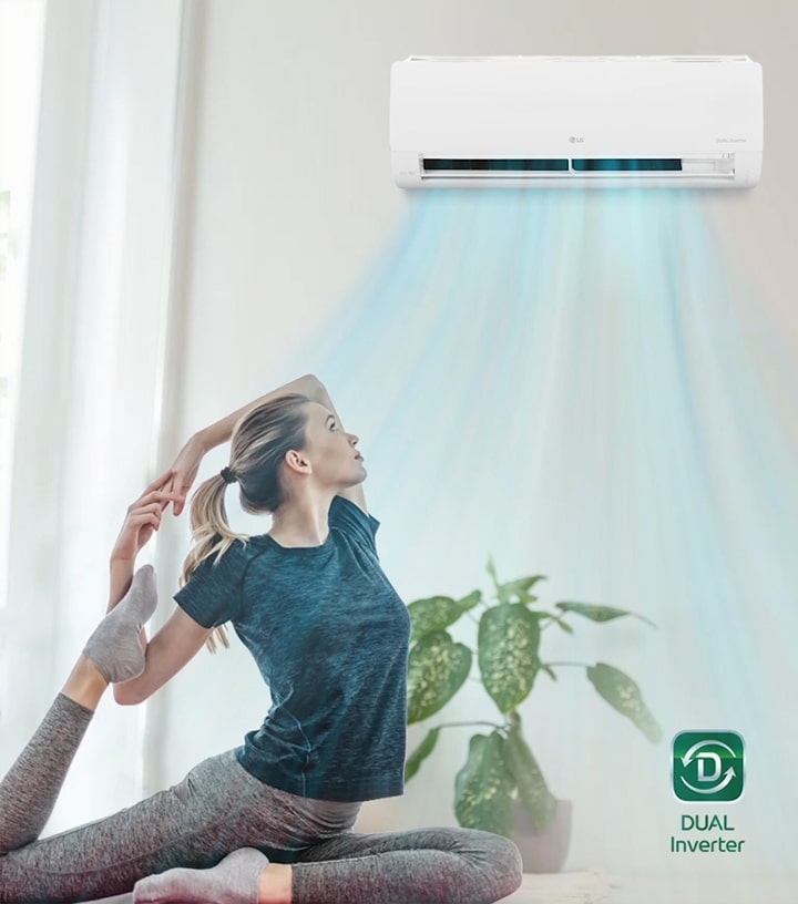 A woman is stretching on the floor. In the background is the air conditioner and blue air flows out over the woman and the room. The Dual Inverter logo is in the bottom right corner.