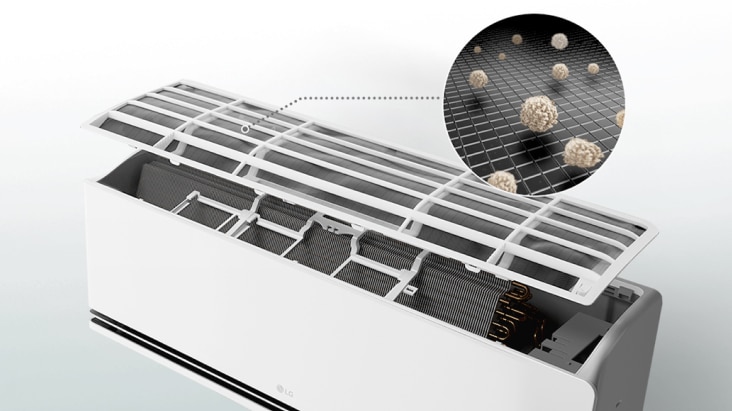 LG air conditioner with open panel showing a pre-filter capturing dust particles in a close-up view.