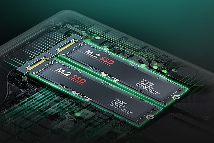 The image highlights the laptop's internal hardware, showcasing two M.2 SSDs installed side by side on the motherboard. The components are illuminated with a green glow, emphasising the dual SSD configuration.