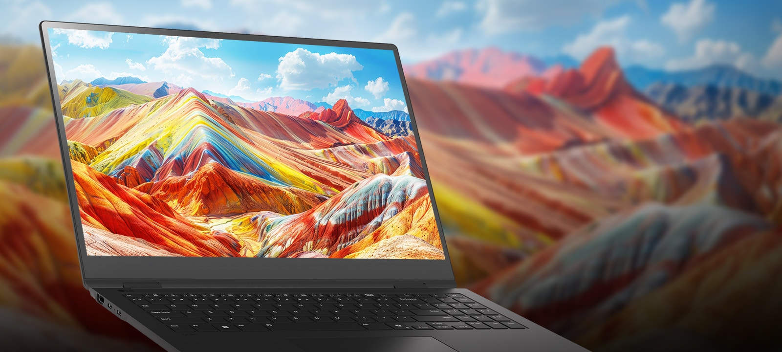 A laptop displaying a vivid and colorful landscape of vibrant mountains on its screen, emphasizing high-resolution and rich color reproduction. The background features a blurred version of the same landscape, drawing attention to the screen quality.