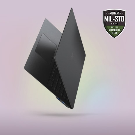 A sleek, partially open laptop with a minimalist design, showcased against a soft gradient background. The MIL-STD durability certification badge is prominently displayed in the top right corner, emphasizing its slim, lightweight, yet durable build.