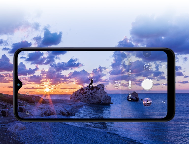 Smartphone photographing a man watching the beach at sunset