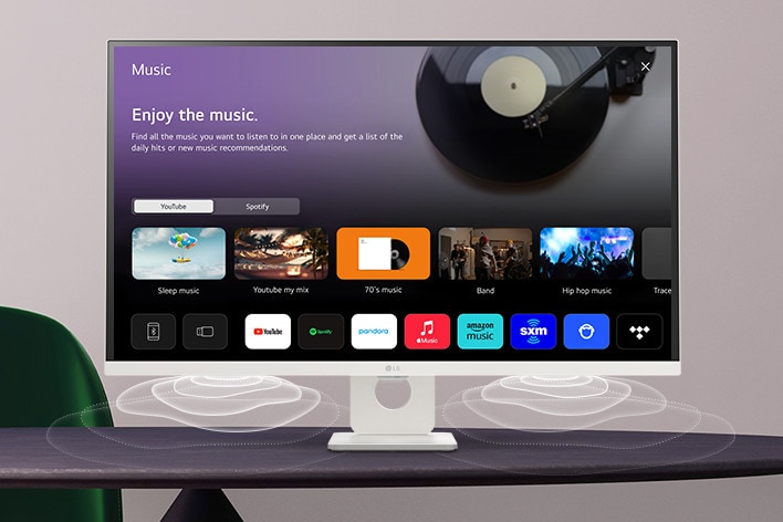 The smart monitor screen placed on the table displays the MUSIC APP screen.