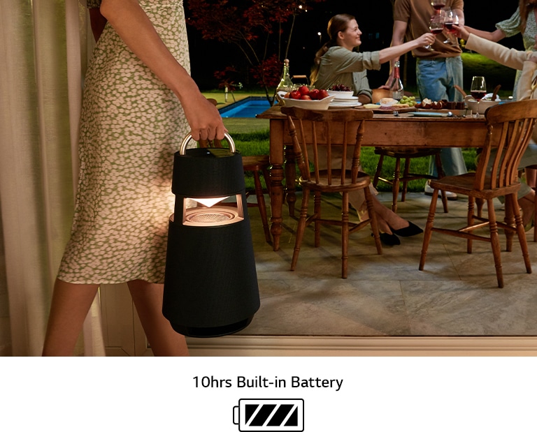 An image of a woman carrying a product to the terrace to represent the portability of the XBOOM 360.