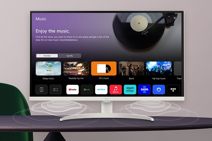 The smart monitor screen placed on the table displays the MUSIC APP screen.