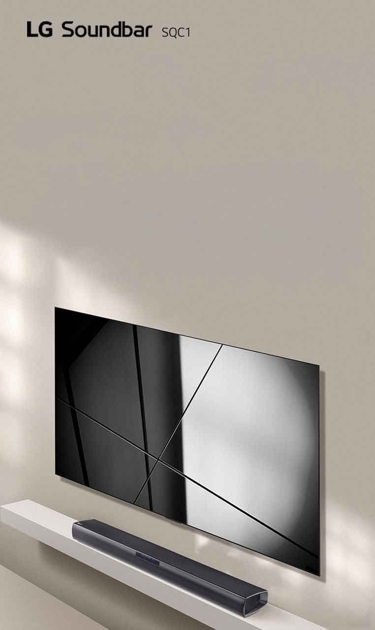 LG sound bar SQC1 and LG TV are placed together in the living room. The TV is on, displaying a graphic image.