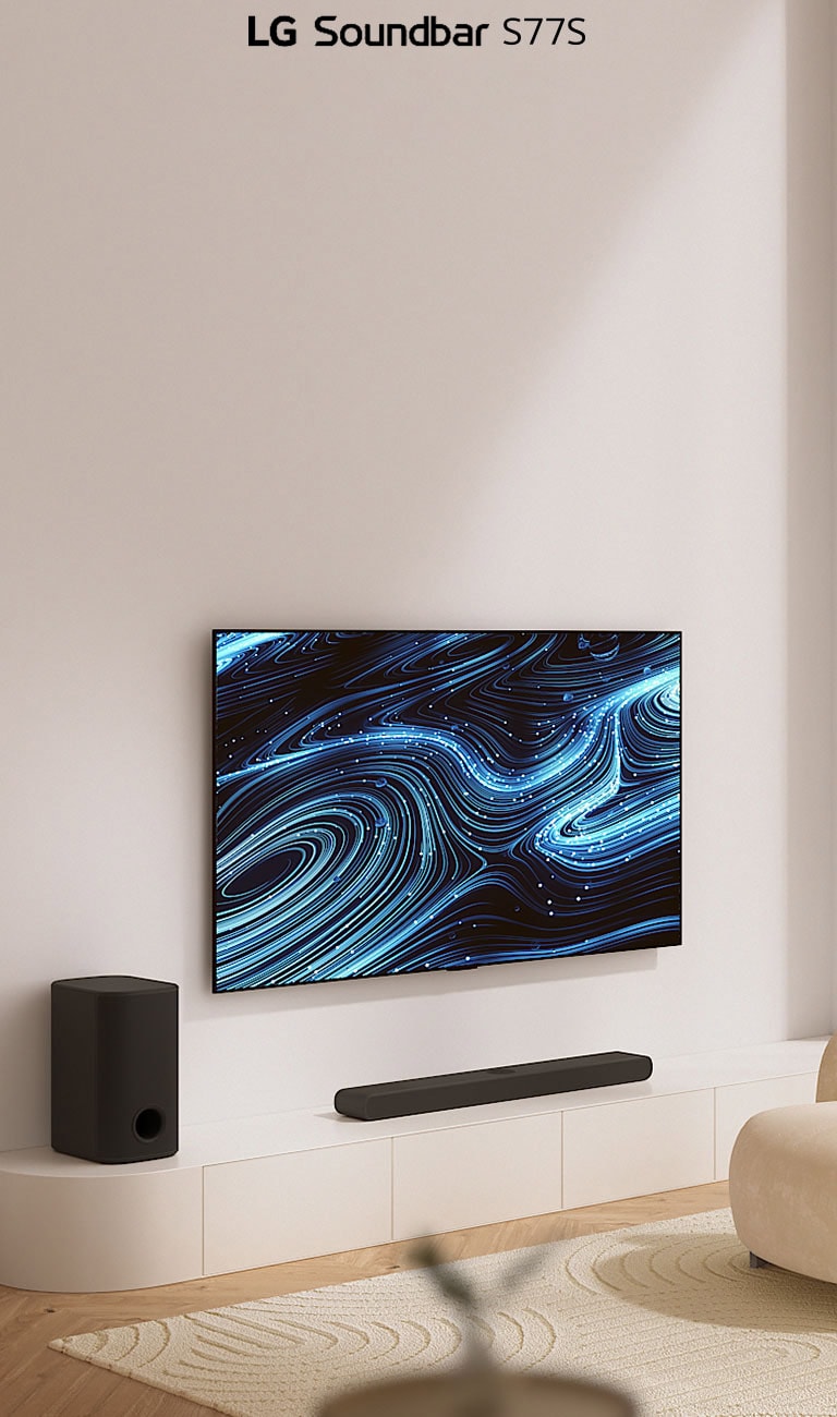TV is hung on the wall, displaying a neon graphic image. Below, soundbar is placed on the white shelf. On the right, a cream-coloured couch is displayed in the living room.