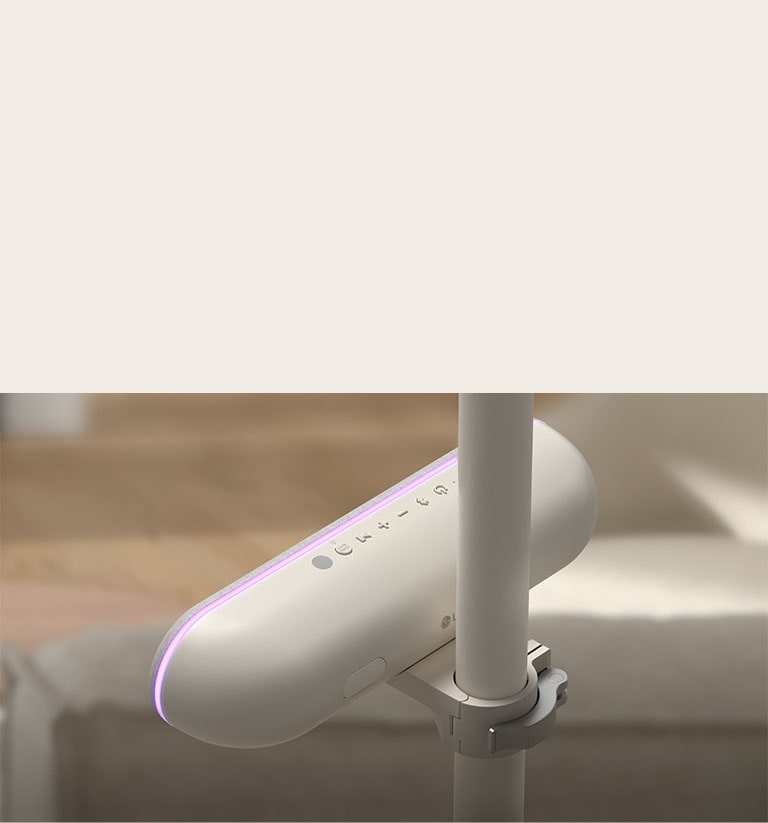 Rear view of the speaker attached to the LG StanbyME to highlight the adjustable cradle. The speaker's purple mood lighting is on.