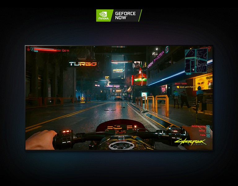 In a scene from Cyberpunk 2077 shown on an LG OLED display, the player drives through a neon-lit street on a motorbike