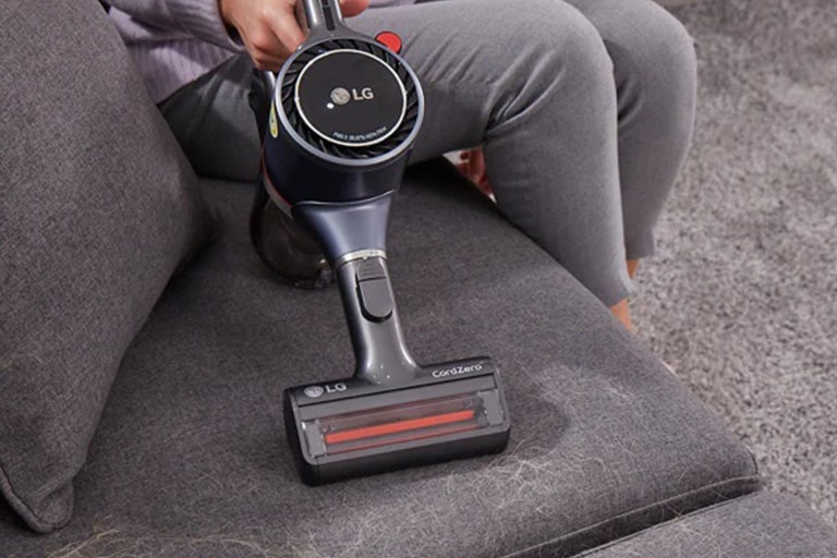 Handheld LG CordZero™ A9 Vacuum cleaner with Power Mini Tool to clean tight spaces such as couch or stairs.