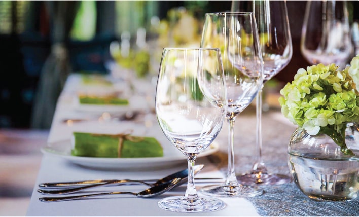 Elegant table setting with glassware and dinnerware for entertaining guests