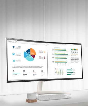 On the table, there is a smart monitor, displaying a home office document being worked on. To the left of the monitor, there is a cup with a handle, and to the right, there is a mobile phone, a pencil holder, and a stand.	