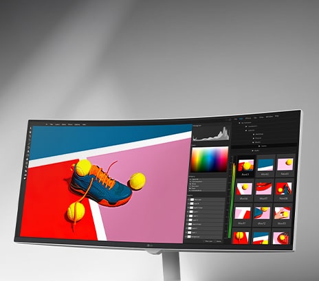 Curved monitor displaying a vibrant winter scene of two people in orange snow gear, shown within a photo editing software interface with color and histogram tools, emphasizing sRGB 99% and HDR support.