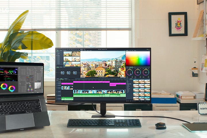 LG UHD 4K monitor feature highlights display a dynamic workspace featuring a laptop and monitor, perfect for video editing and creative projects with stunning visuals.