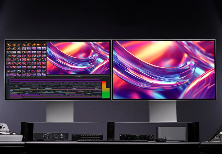 2 identical UltraFine monitors with images on them are placed in a dark studio.