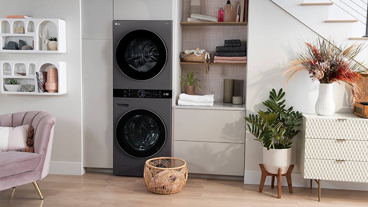 Living room with a washer and dryer stacked on top of each other 
