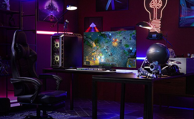 A man plays a game on the smallest LG OLED television while sitting at a desk