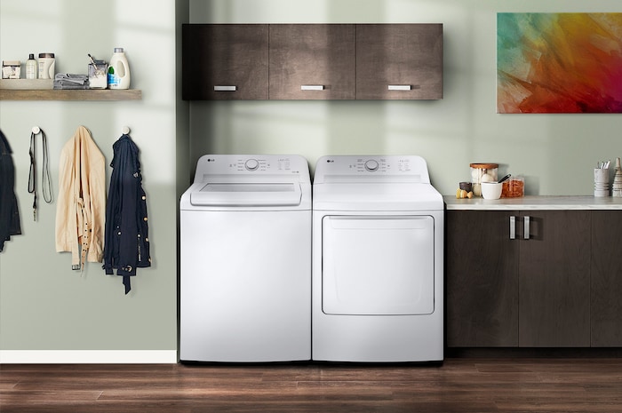 L'ensemble lave-linge et sèche-linge à chargement par le haut LG (WT6105CW) Blanc, présentant son esthétique classique et son intégration harmonieuse dans une buanderie moderne.
