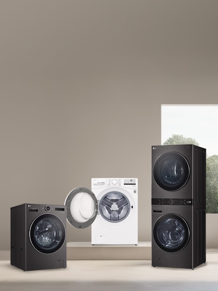 3 appareils dont une laveuse à chargement frontal noire, une laveuse blanche et une WashTower dans une buanderie moderne.