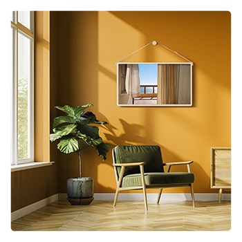 LG StanbyME 2 Max LX6 Movable Screen is wall-mounted with a hanging strap in a warm-toned room, displaying a balcony ocean view through curtains, highlighting flexible placement and decorative integration within a cozy interior.
