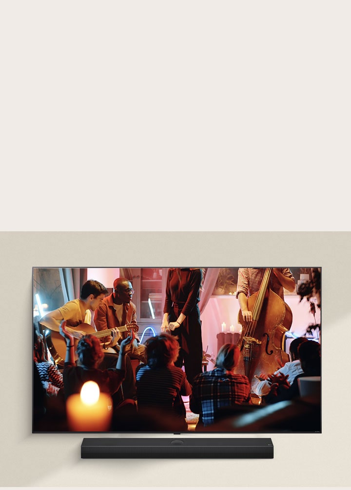 Ein gemütliches Konzert wird auf einem LG TV mit einer LG Soundbar darunter abgespielt.