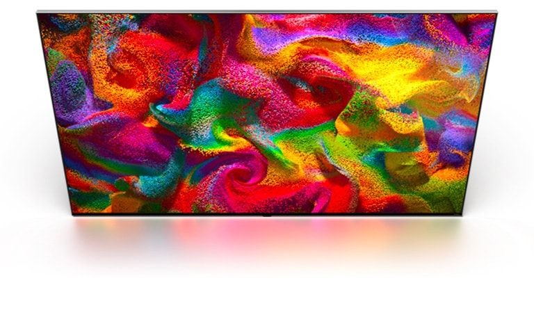 Du sable multicolore explose dans toutes les directions, formant un motif tourbillonnant, puis apparaît à l’écran d’une LG TV.