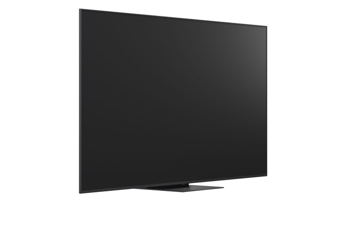 A girl and a dog are seated in front of a LG QNED TV mounted on a wall depicting three elephants walking outwards above a LG Soundbar. The title talks about how every action is more thrilling on a massive screen.