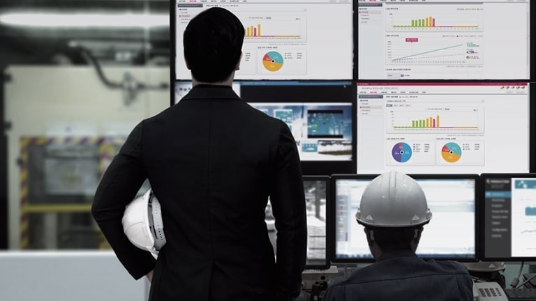 A man looking at many screens displaying LG's Energy Management Service.