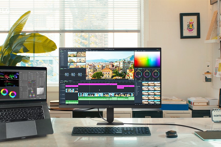 Las características más destacadas del monitor LG UHD 4K muestran un espacio de trabajo dinámico compuesto por un ordenador portátil y un monitor, ideal para la edición de vídeo y proyectos creativos con imágenes impresionantes.
