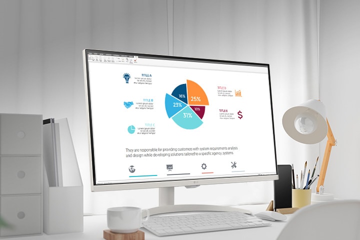 On the table, there is a smart monitor, displaying a home office document being worked on. To the left of the monitor, there is a cup with a handle, and to the right, there is a mobile phone, a pencil holder, and a stand.	