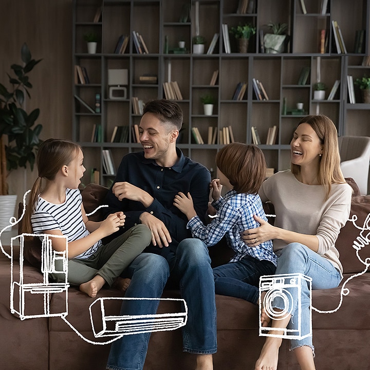 The family is sitting on the couch laughing. Around them are white line-drawing of refrigerator, washing machine, and air conditioner.