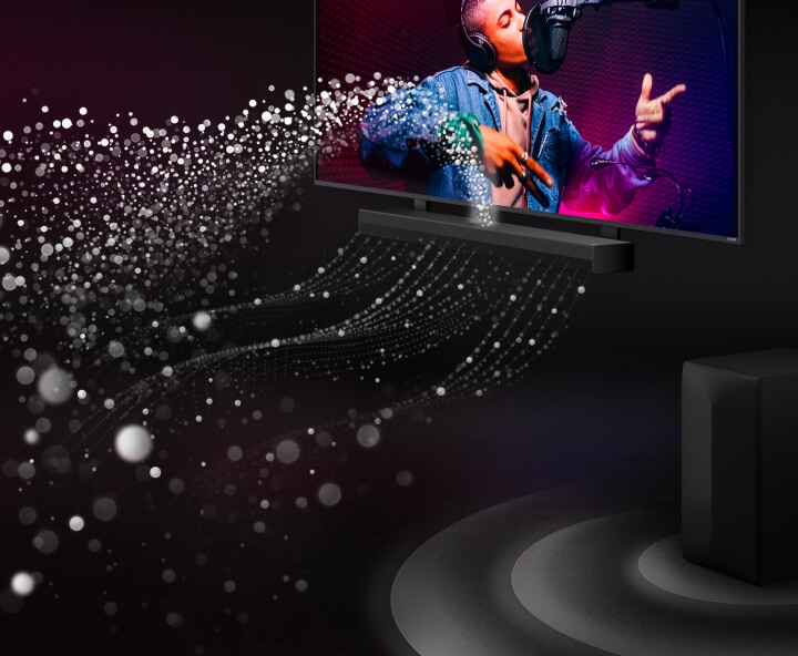 LG Soundbar y LG TV en una habitación negra interpretando una actuación musical. Gotas blancas que representan ondas sonoras se disparan hacia arriba y hacia adelante desde la barra de sonido. Un subwoofer crea un efecto de sonido desde abajo.