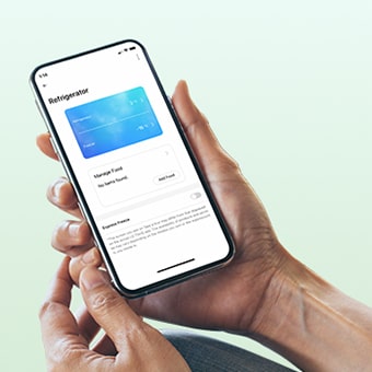 Hands holding a phone with LG ThinQ app on