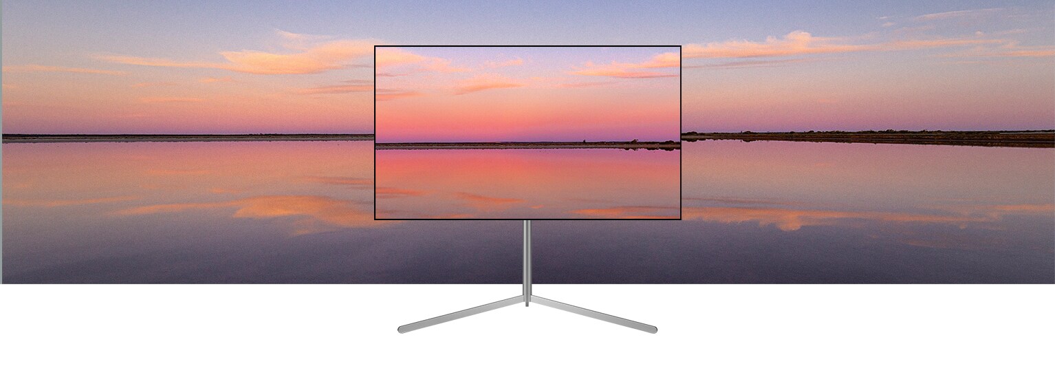 Un televisor LG OLED en un soporte de galería muestra una puesta de sol azul y rosa que se funde con el fondo