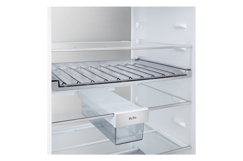 LG bottom freezer (GBBS726BEV) installed flush in tall warm beige wall with white arrows pointing to top side and front surfaces