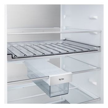 LG bottom freezer (GBBS726BEV) installed flush in tall warm beige wall with white arrows pointing to top side and front surfaces