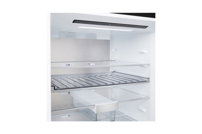 LG bottom freezer (GBBW726AEV) installed flush in tall warm beige wall with white arrows pointing to top side and front surfaces